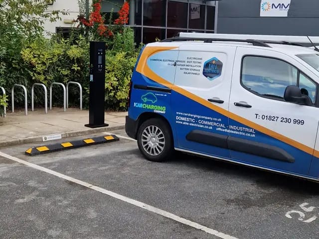 Pedestal charger in a business car park with our van alongside
