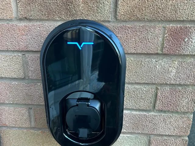 Smart home charger fitted on a brick wall