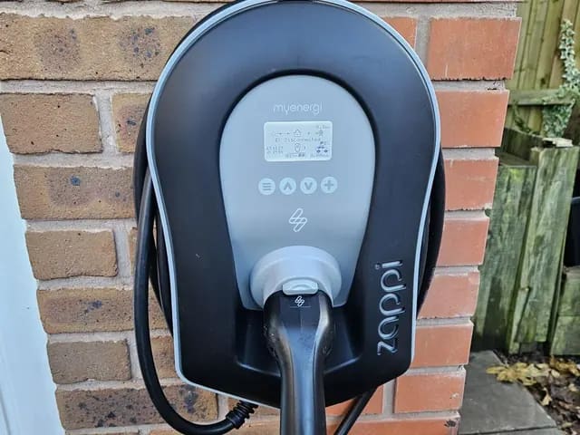 Solar-compatible home charger on a house wall