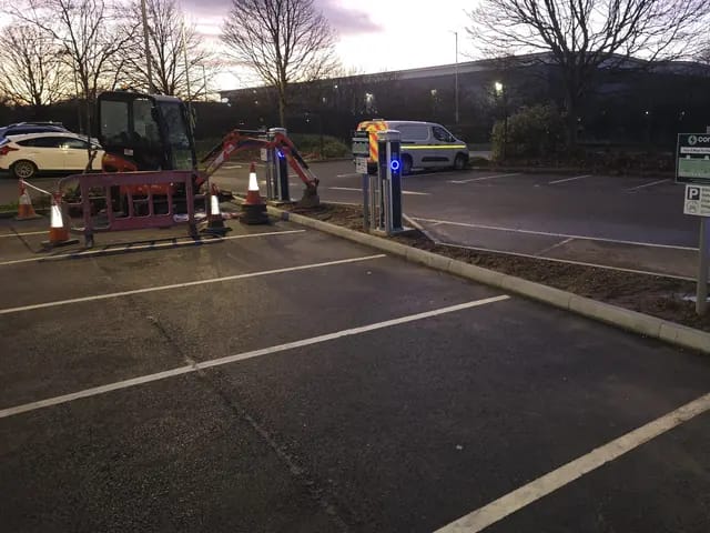 Hotel car park chargers being commissioned at dusk