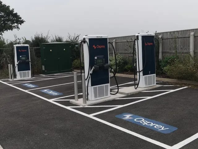 Three rapid chargers and a feeder pillar at a public charging hub